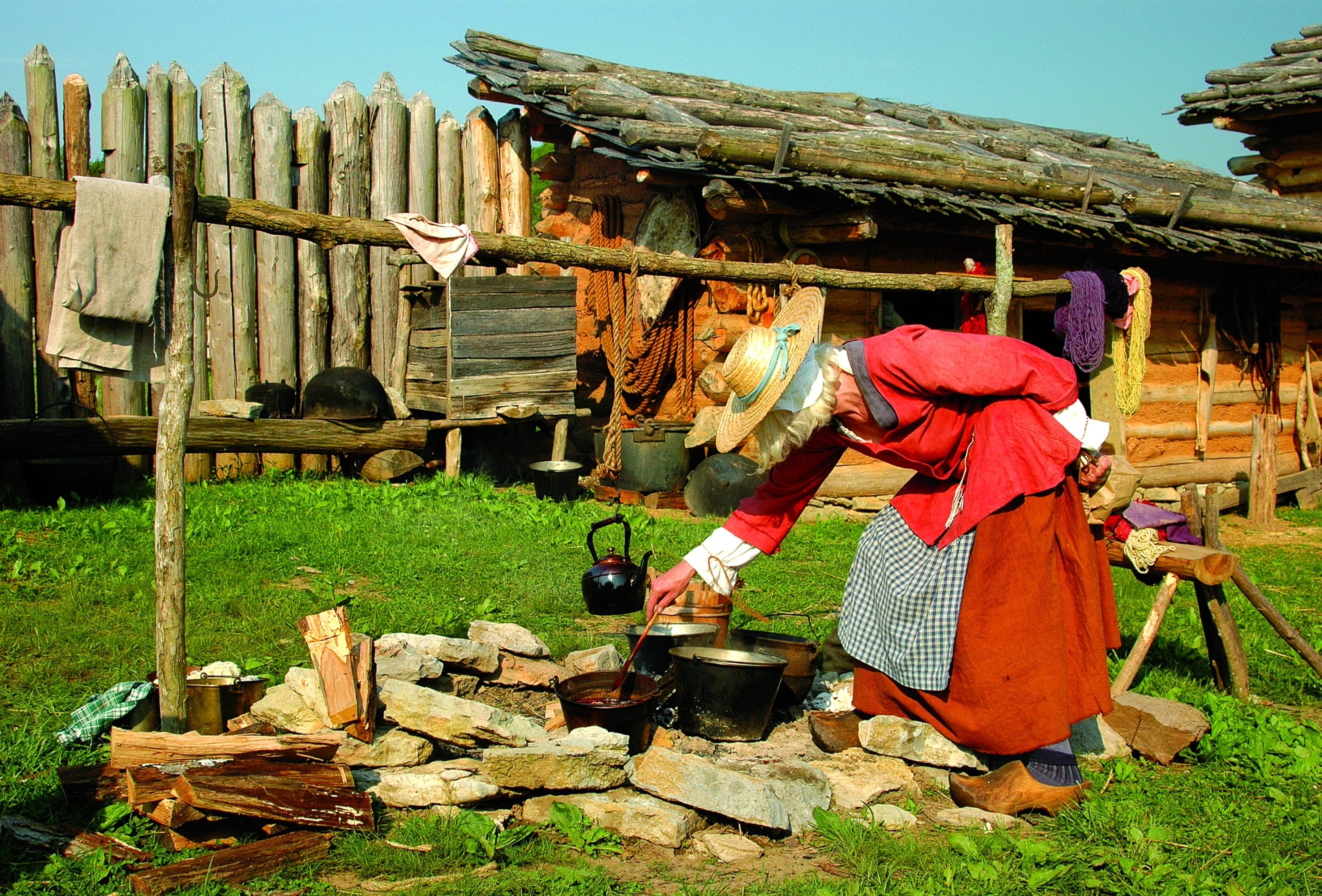 Volunteer dressed as a pioneer working at Wilderness Road State Park.